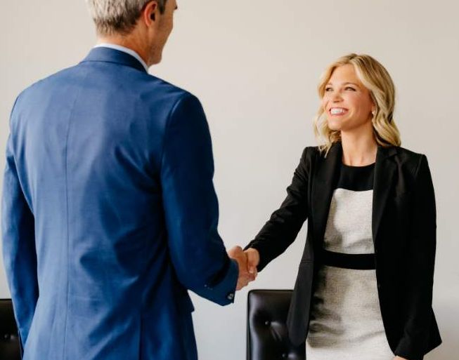 Angela shaking hands with an attorney