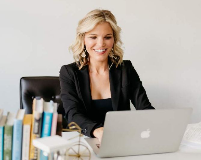 Angela at her laptop reviewing candidates